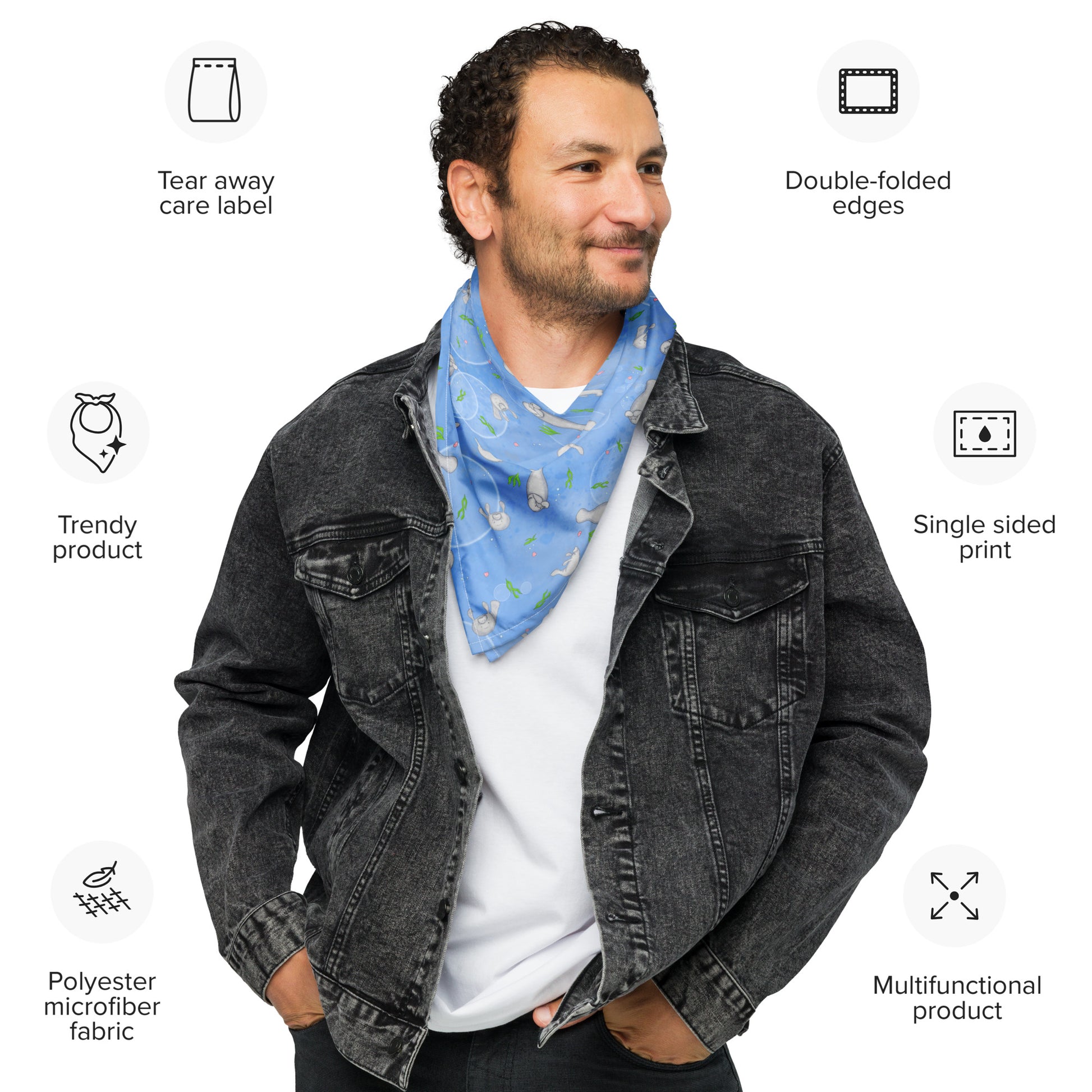Manatee bandana. Shown as a neck bandana on a male model. Features patterned design of hand-illustrated manatees, seaweed, seashells, and bubbles on a blue  background.