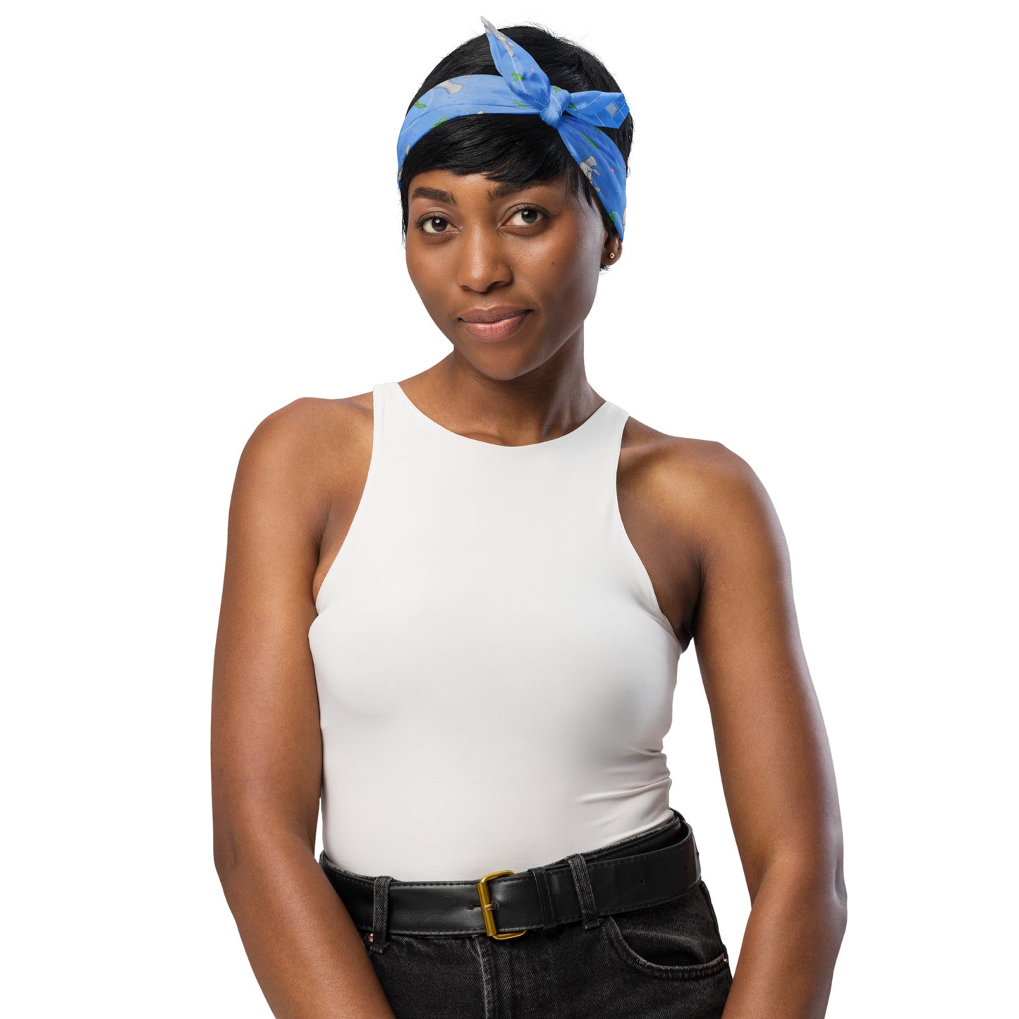 Manatee bandana. Shown as a headband on a female model. Features patterned design of hand-illustrated manatees, seaweed, seashells, and bubbles on a blue  background.