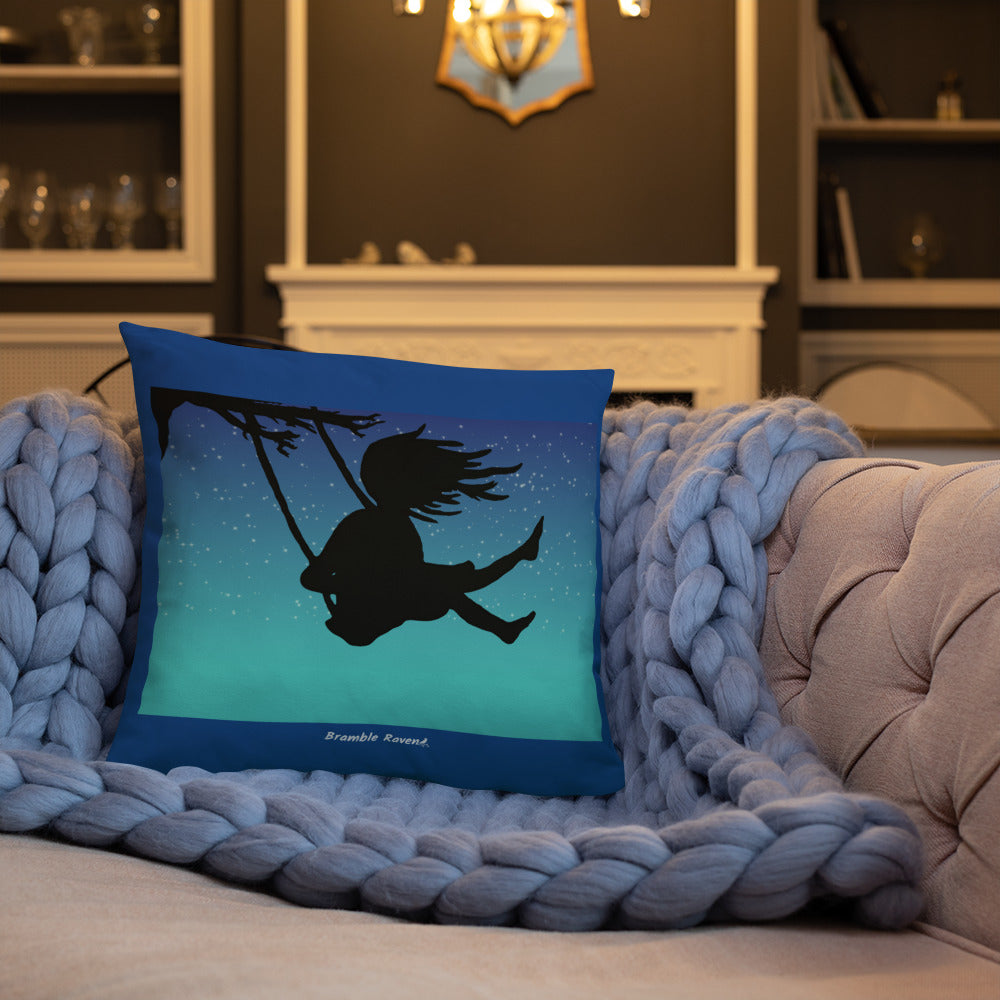 Original Swing Free design of a girl's silhouette in a tree swing against the backdrop of a blue starry sky. Rectangular image on front of pillow with blue background fabric. Pillow has design on both sides. 18 by 18 inch accent pillow. Back image shown on blue knitted blanket on tan sofa.