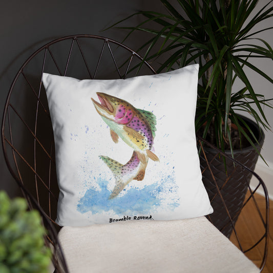 18 by 18 inch accent pillow. Features original watercolor painting of  rainbow trout leaping from the water on a white background. Double-sided design. Shown on wicker chair.