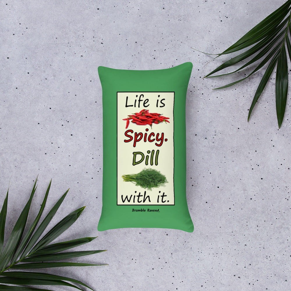 Life is spicy. Dill with it. Phrase with images of chili peppers and dill weed. Rectangular frame for saying on green background. 20 by 12 inch accent pillow. Double sided image. Shown on the floor with palm fronds.