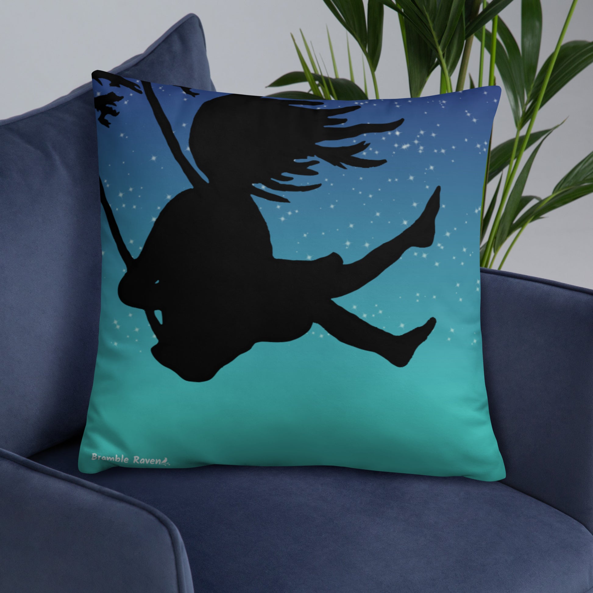 Original Swing Free design of a girl's silhouette in a tree swing against the backdrop of a blue starry sky. Pillow has design on both sides. 22 by 22inch accent pillow. Image shows back which has the design covering the entire side. Shown on blue sofa.