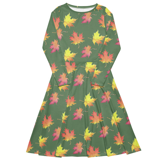 Long sleeve midi dress. Watercolor fall leaves patterned over an amulet green background. Soft and flattering fit. Boatline neck, fitted waist, flared bottom, and side pockets.