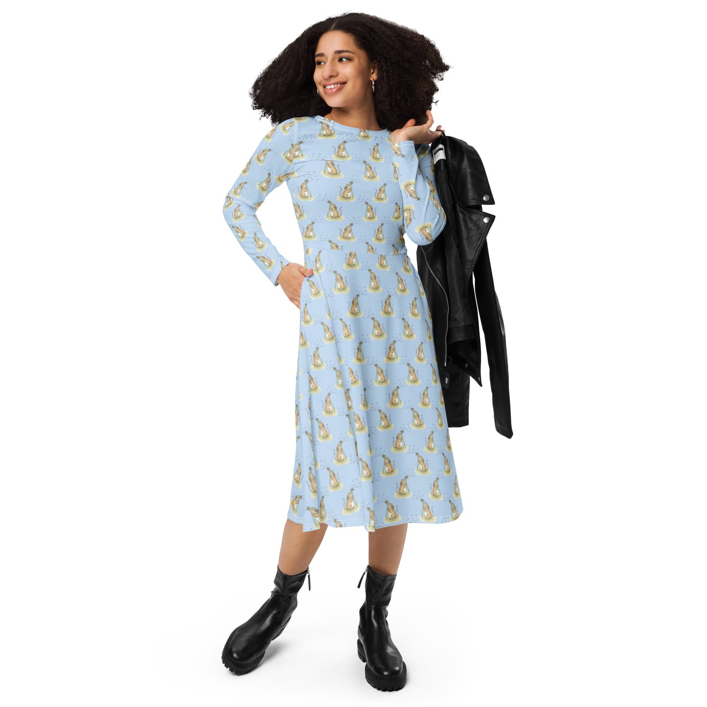 Dandelion Wish patterned long sleeve midi dress. Features patterned design of a mouse making a wish on a dandelion fluff against a light blue background. Dress has boat neckline, fitted waist, flared bottom, and side pockets.  Shown on female model with black jacket over her shoulder.