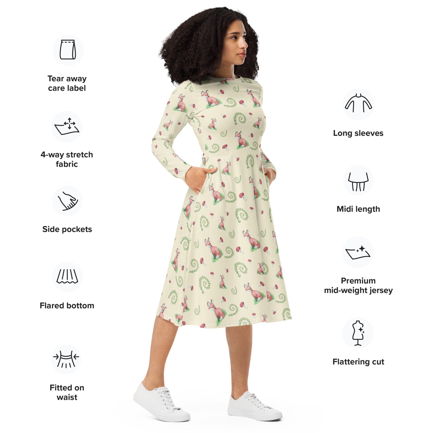 Fox pattern long sleeve midi dress with side pockets, fitted waist, and flared bottom. Foxes, ferns, and mushrooms are patterned on the apricot white fabric. Soft and comfortable. Shown on female model facing right.