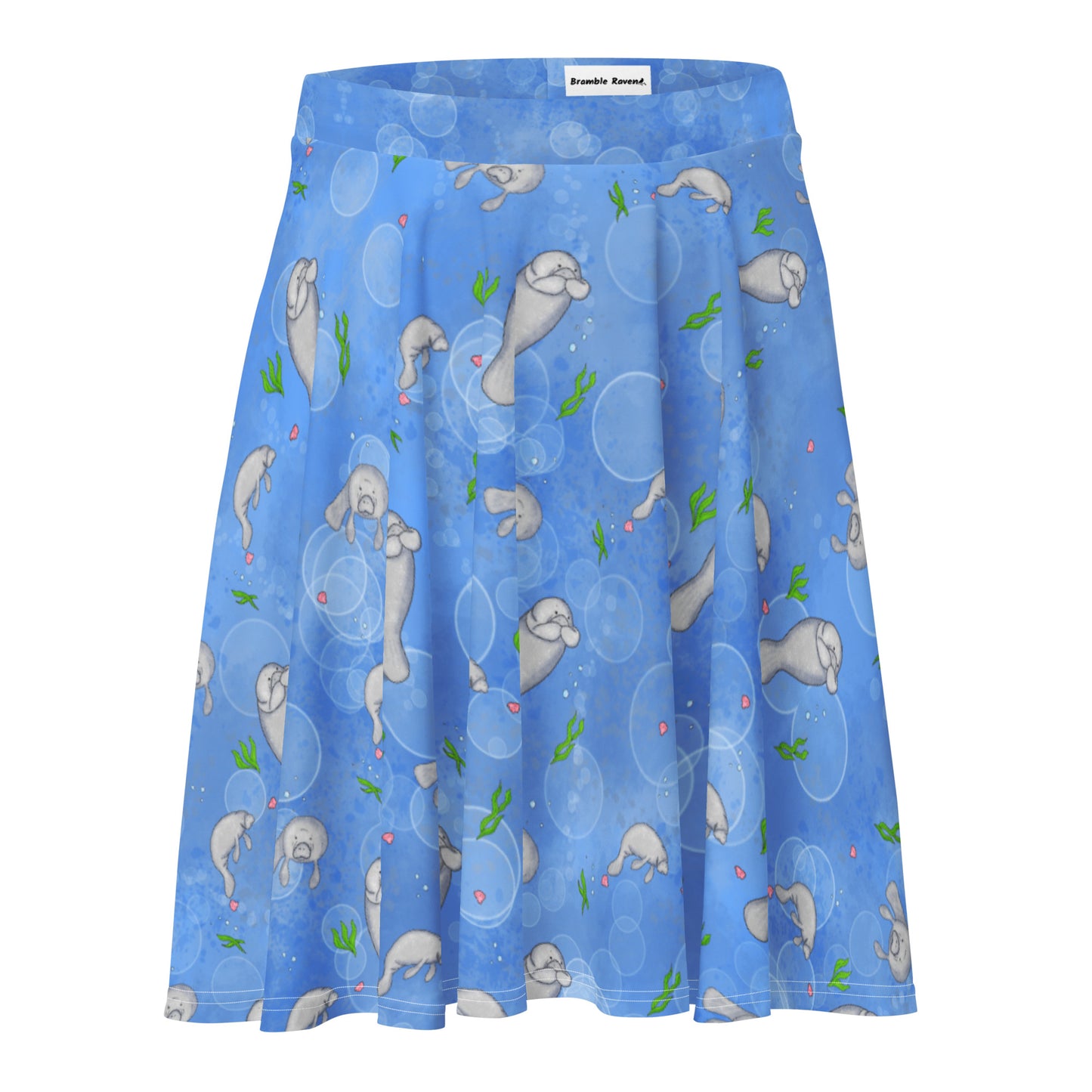 Manatee patterned skater skirt with elastic waist and mid-thigh length skirt. Has a pattern of manatees, seashells, seaweed and bubbles on a blue background.