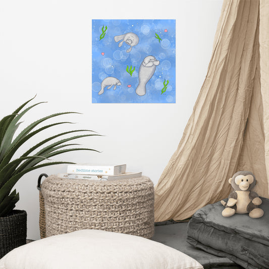 16 x 16 inch matte poster art print. Features three manatees with accenting seashells, seaweed, and bubbles on a blue background. Shown on the wall above an ottoman and curtain.