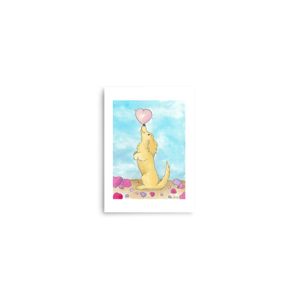 5 x 7 inch enhanced matte paper art print. Watercolor painting entitled Puppy love. Design shows a cute puppy balancing a heart on its nose, with hearts on the floor and a blue sky background.