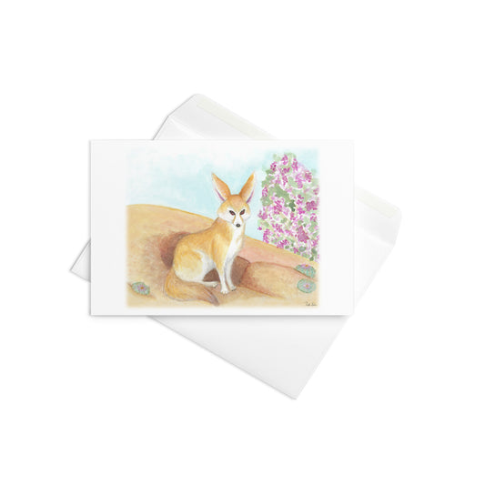4 by 6 inch greeting card with white envelope. Features watercolor print of a fennec fox in the desert. Inside is blank. Made of durable paperboard with vibrant printing.