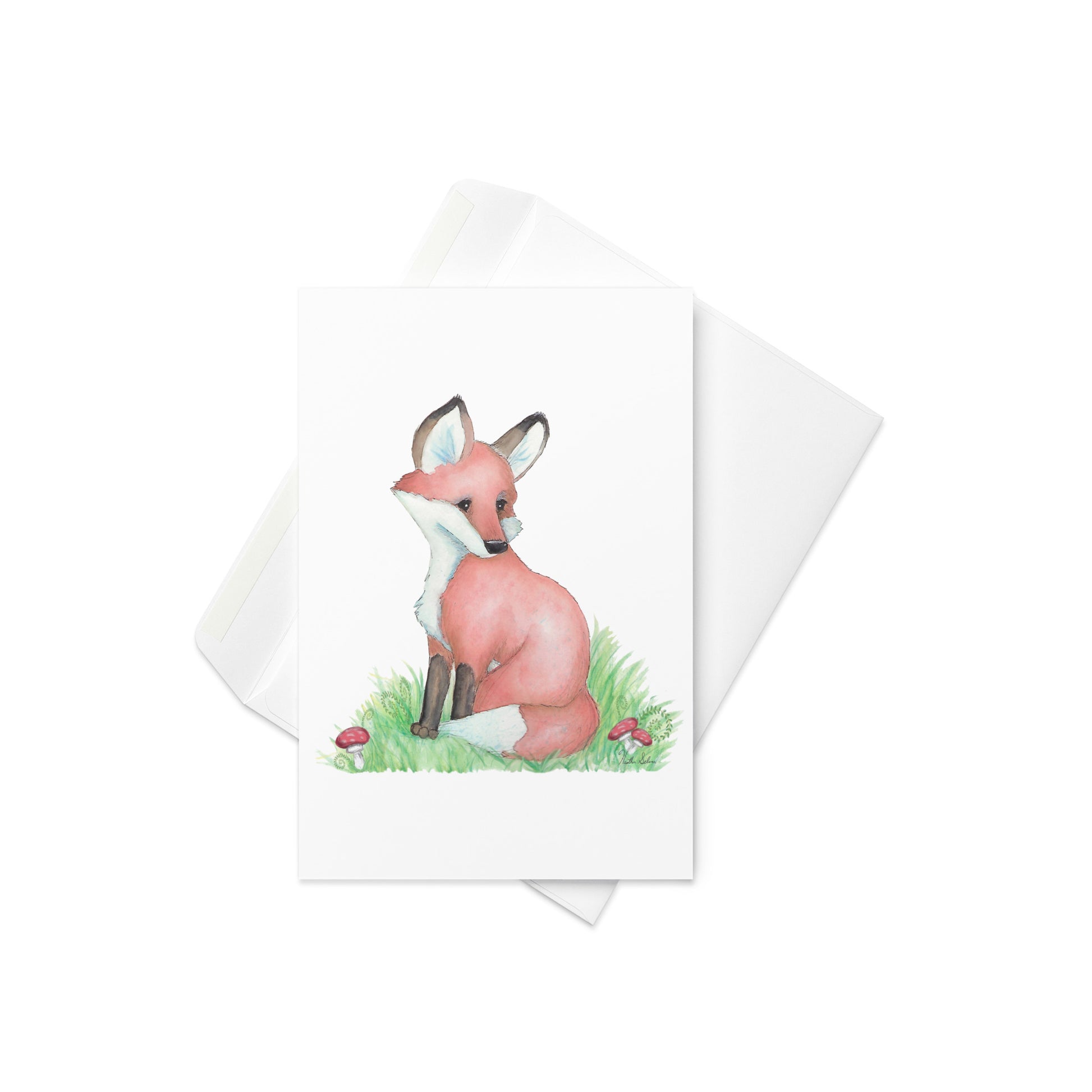 4 by 6 inch forest fox greeting card. Front has watercolor print of a fox in the grass by mushrooms and ferns. Inside is blank. Comes with a white envelope. Made of durable paperboard with vibrant printing.