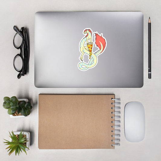 Maisy the Fuzzy Noodle Dragon holding a slice of pizza. Original character design kiss cut vinyl sticker with white border. 5.5 inches tall. Shown on a laptop.