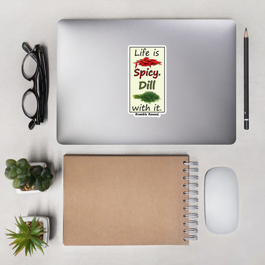 Life is spicy. Dill with it. Phrase with images of chili peppers and dill weed. Design in a rectangle frame with light yellow background. 5.5 inch kiss cut vinyl sticker with white border. Shown on a laptop.