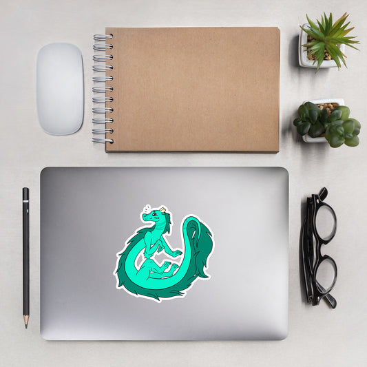 Minty the Fuzzy Noodle Dragon. Original character design kiss-cut vinyl sticker with white border. 5.5 inches tall. Shown on a laptop.