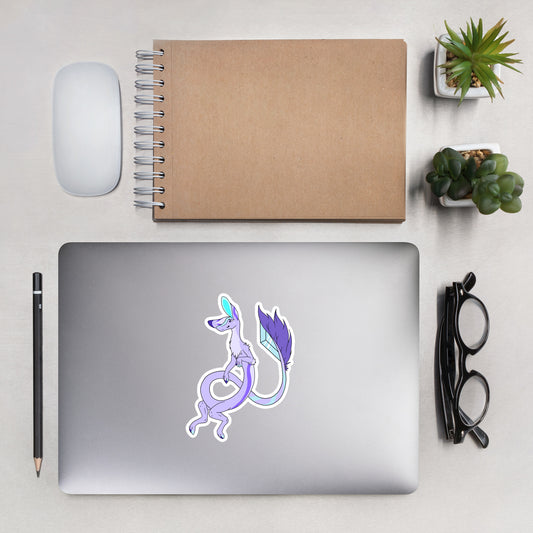 Layla the lavender Fuzzy Noodle Dragon. Original character design kiss-cut vinyl sticker with white border. 5.5 inches tall. Shown on a laptop.