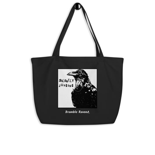 Original Silently Judging crow design. Silently Judging text. Black crow with monocle in square frame. Printed on large black colored eco tote. 20 by 14 by 5 inches. 100% recycled cotton.