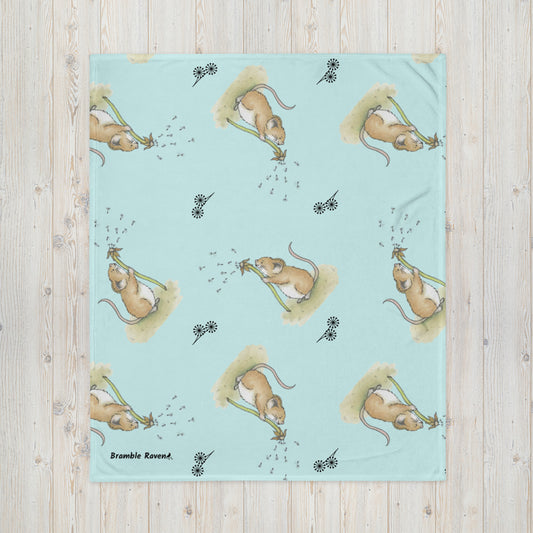 Original Dandelion Wish design of cute watercolor mouse blowing dandelion seeds. Patterned on a light blue background with black dandelion flower symbols. 50 by 60 inch throw blanket. 