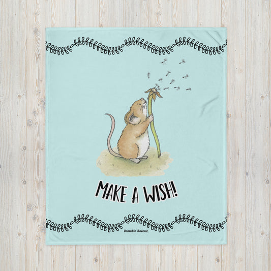 Original Dandelion Wish design of cute watercolor mouse blowing dandelion seeds on a light blue background. Black vine border on top and bottom. Make a Wish phrase below mouse graphic. 50 by 60 inch throw blanket. 