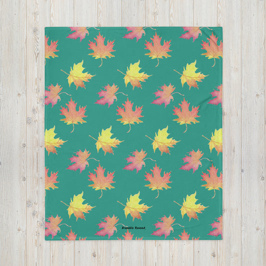 50 by 60 inch soft throw blanket featuring watercolor fall leaves patterned on a dark green background.