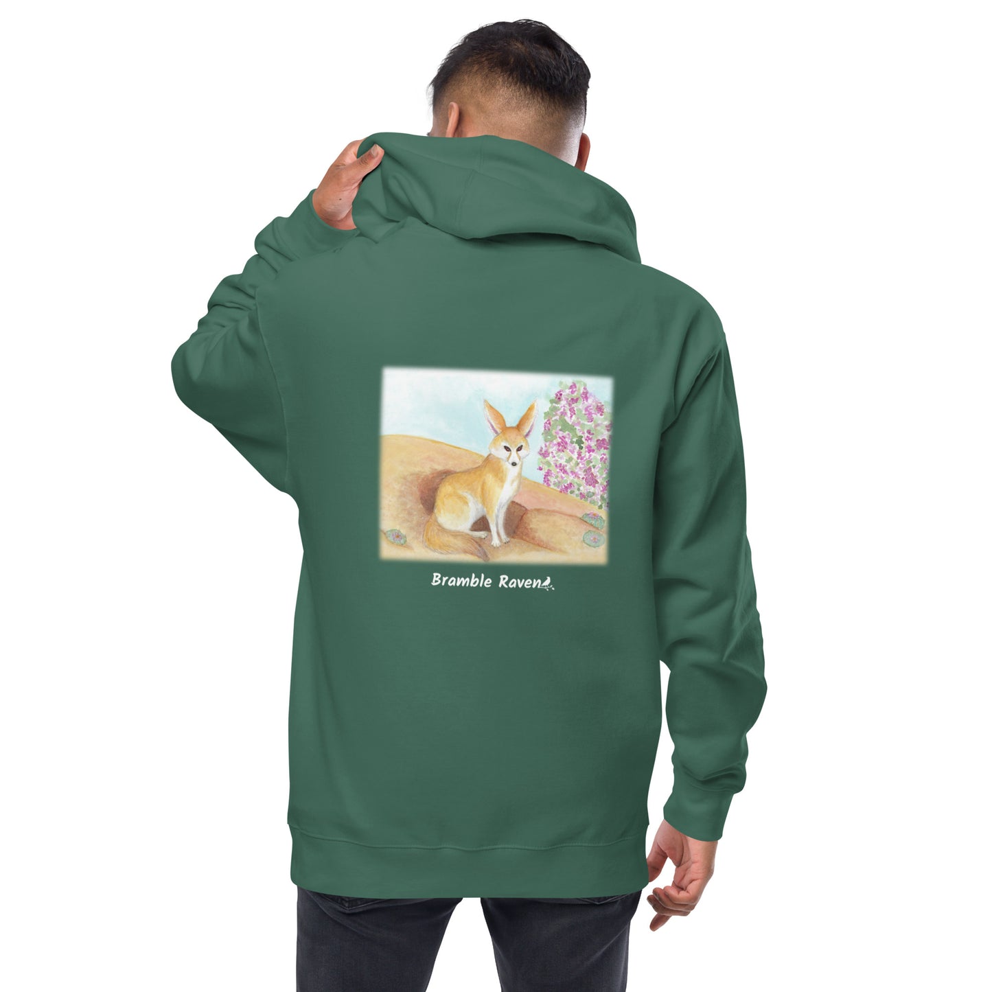 Unisex fleece-lined zip-up alpine green colored hoodie. Features original watercolor painting of a fennec fox in the desert on the back of the hoodie. Shown on male model.