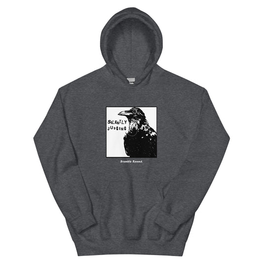 Unisex heather grey colored hoodie with silently judging text by black crow wearing a monocle in a square frame.  Design on the front of hoodie.