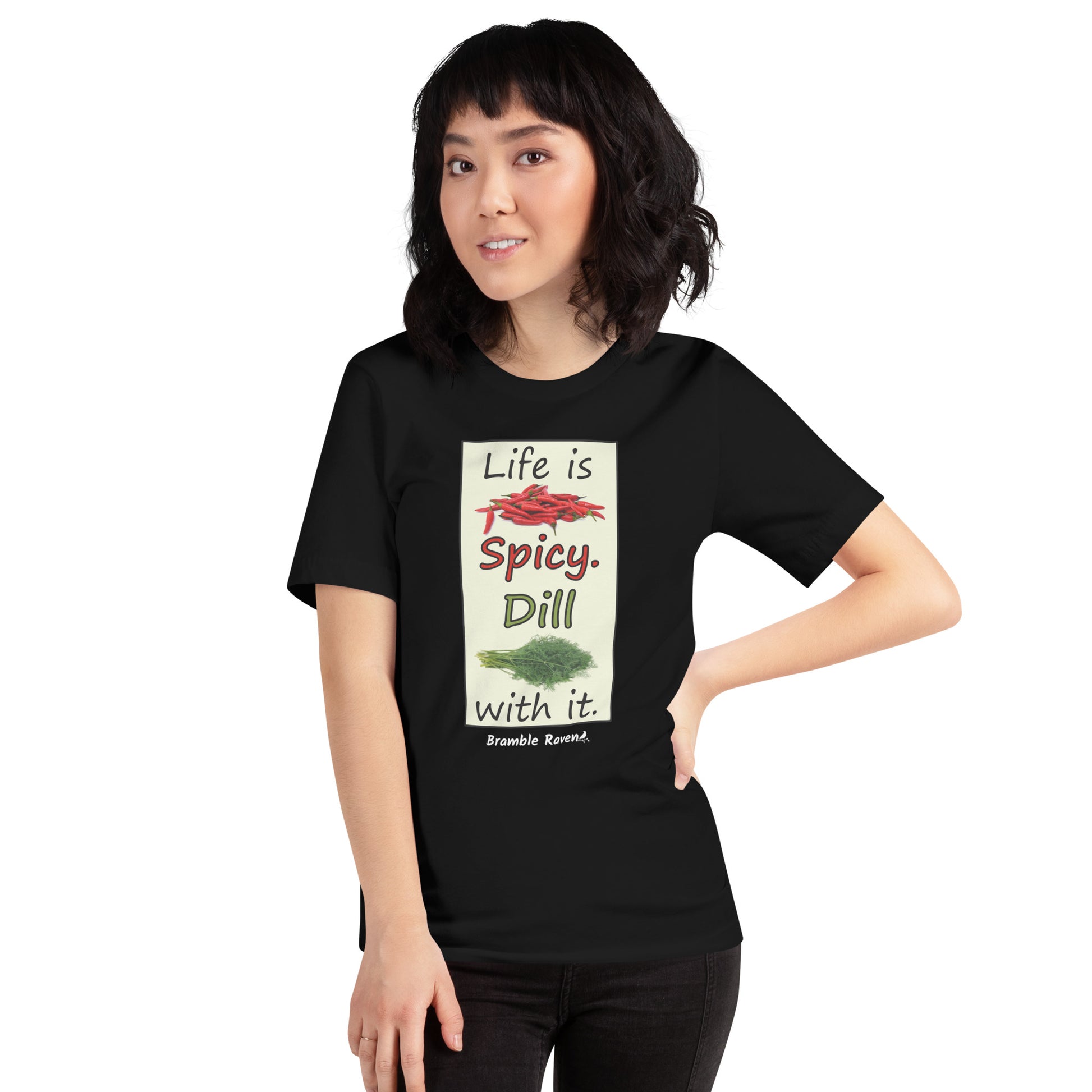 Life is spicy. Dill with it. Phrase with images of chili peppers and dill weed. Rectangular frame for saying on black colored unisex t-shirt. Shown on female model.