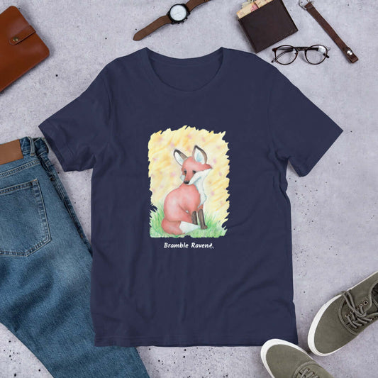 Unisex navy blue t-shirt. Features original watercolor painting of a fox in the grass against a yellow background.