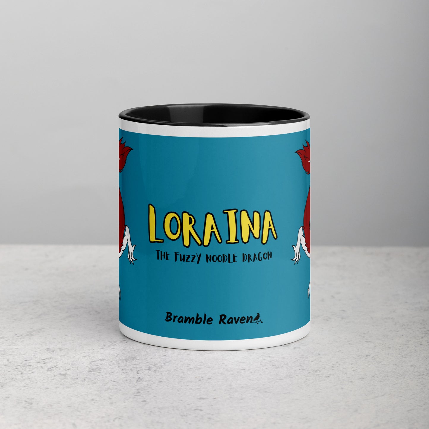 11 ounce ceramic mug with black handle, rim and inside color. Features double-sided image of Loraina the Fuzzy Noodle Dragon on a dark blue background. Mug is microwave and dishwasher safe. Front view shows Loraina The Fuzzy Noodle Dragon text and Bramble Raven logo.