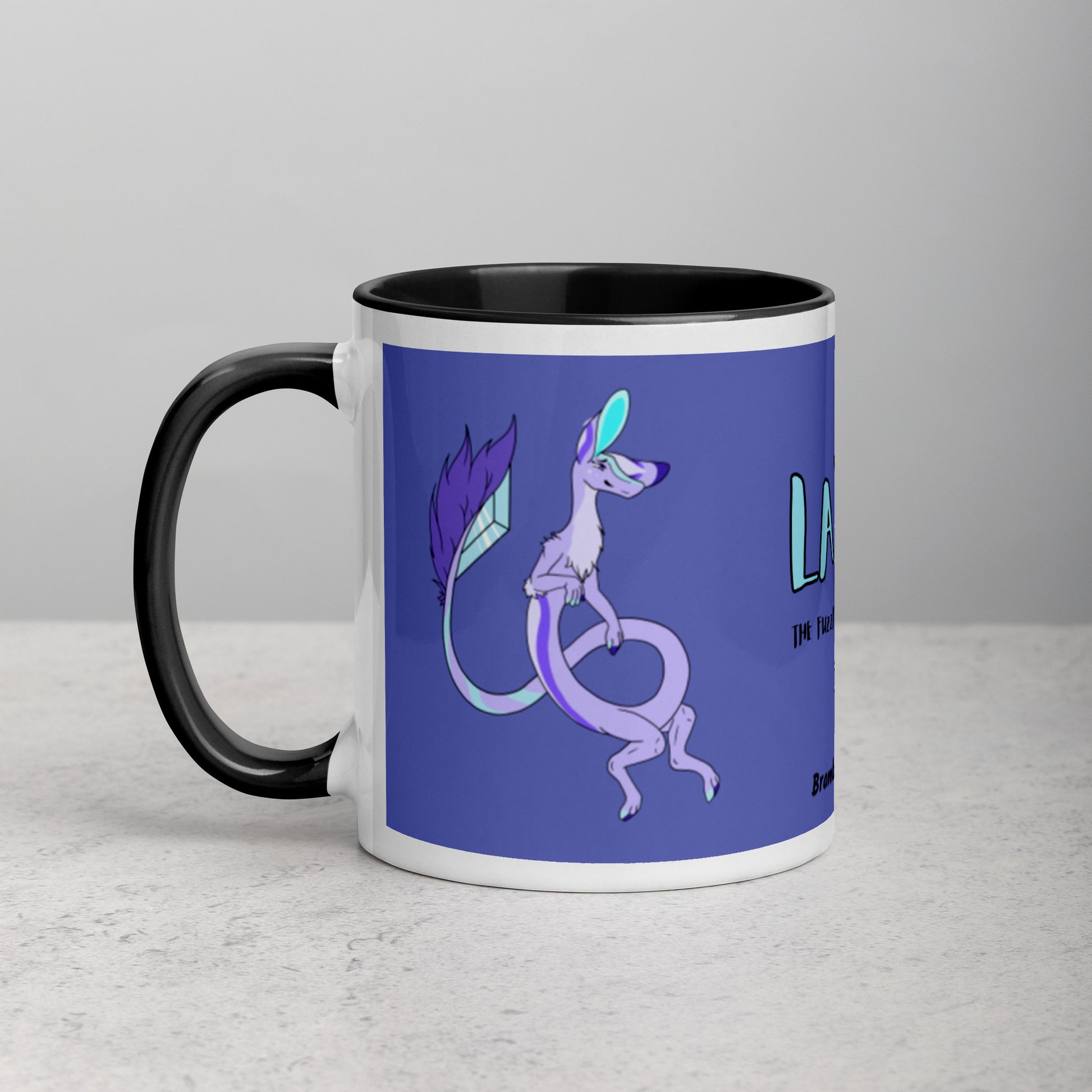 11 ounce white ceramic mug. Black inside and handle. Features double-sided image of Layla the Lavender Fuzzy Noodle Dragon. Shown on tabletop.