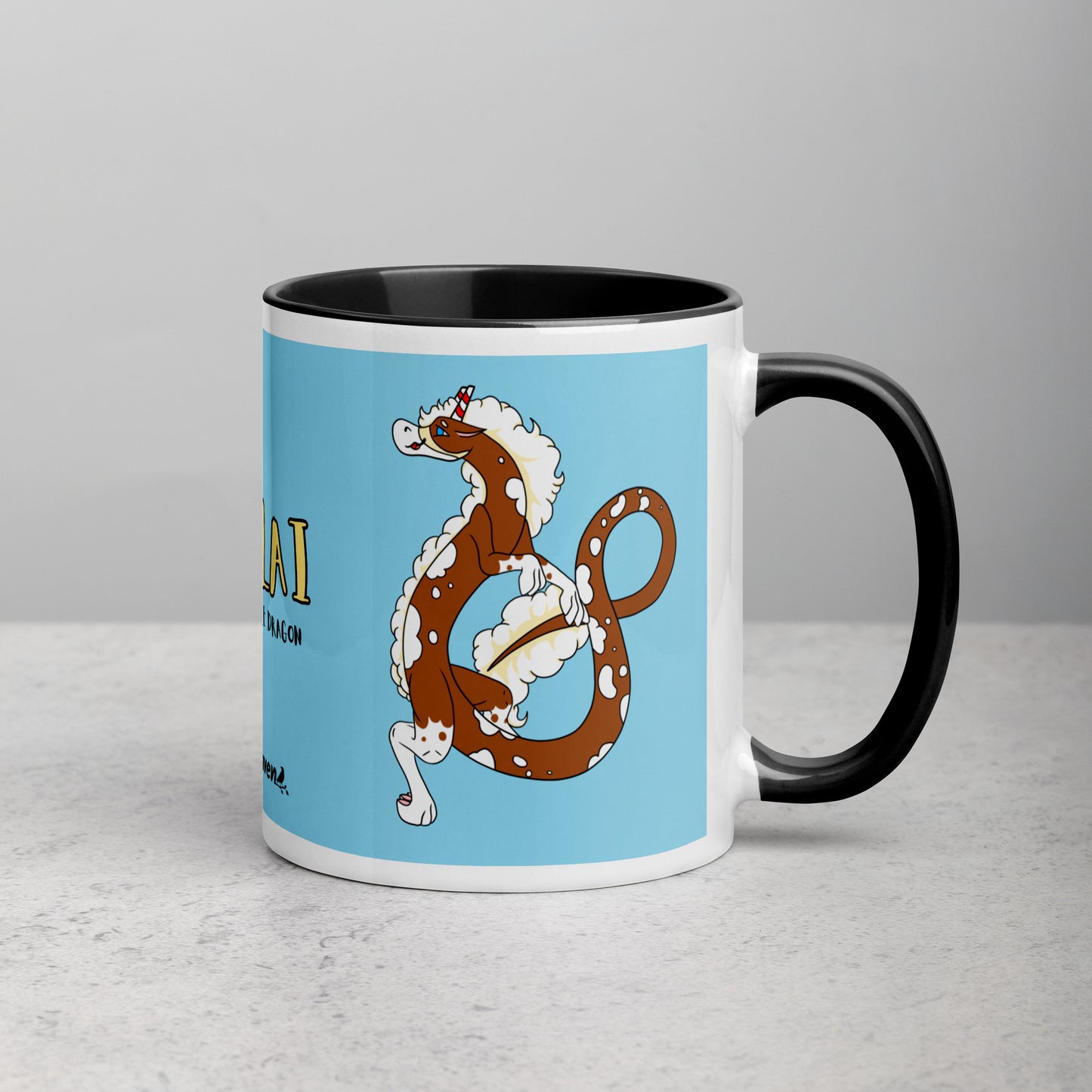 11 ounce ceramic mug with black handle, rim and inside color. Features double-sided image of Nikolai the Fuzzy Noodle Root beer float dragon on a light blue background. Mug is microwave and dishwasher safe. 