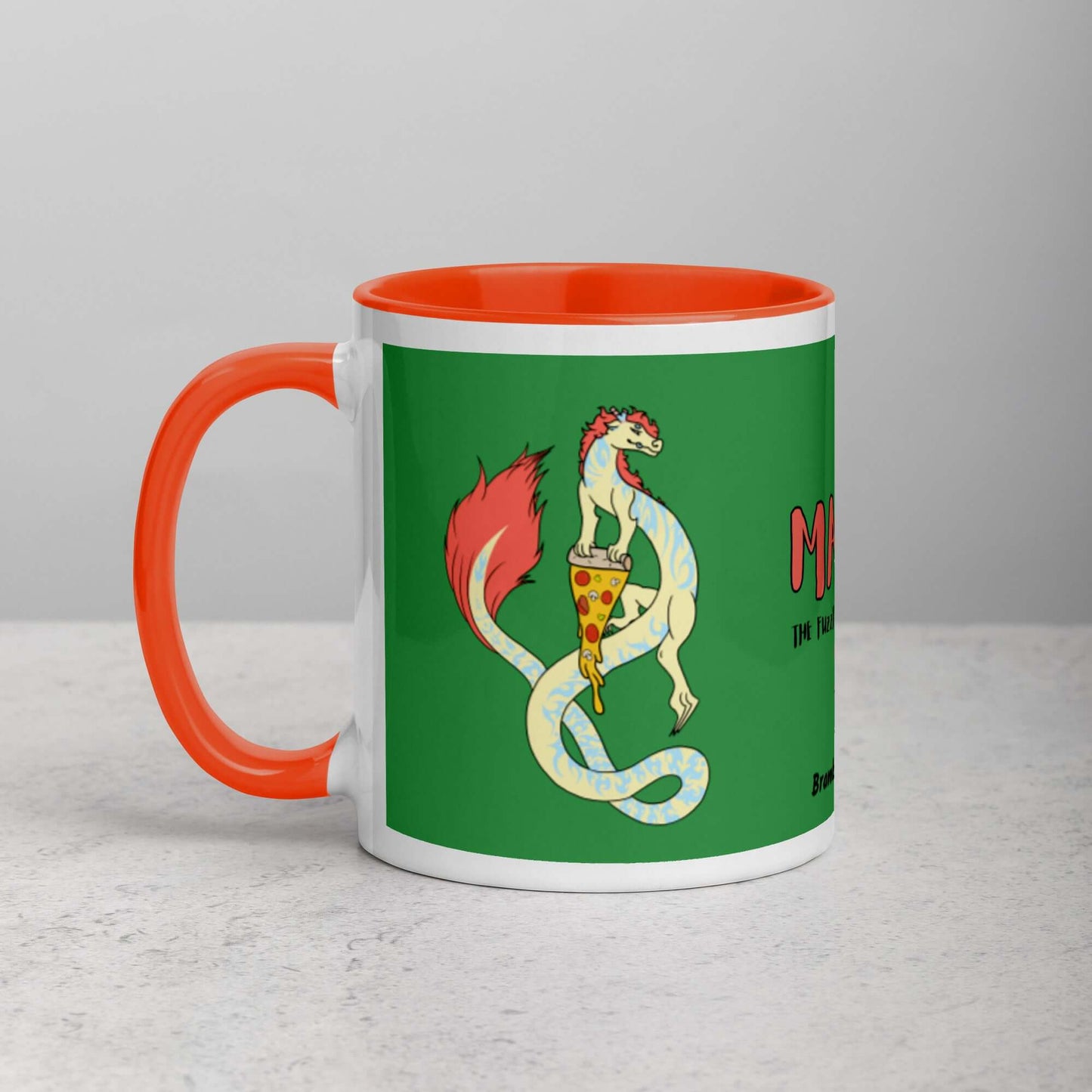 11 ounce white ceramic mug. Orange inside and handle. Features double-sided image of Maisy the Fuzzy Noodle Dragon with a slice of pizza. Shown on tabletop.