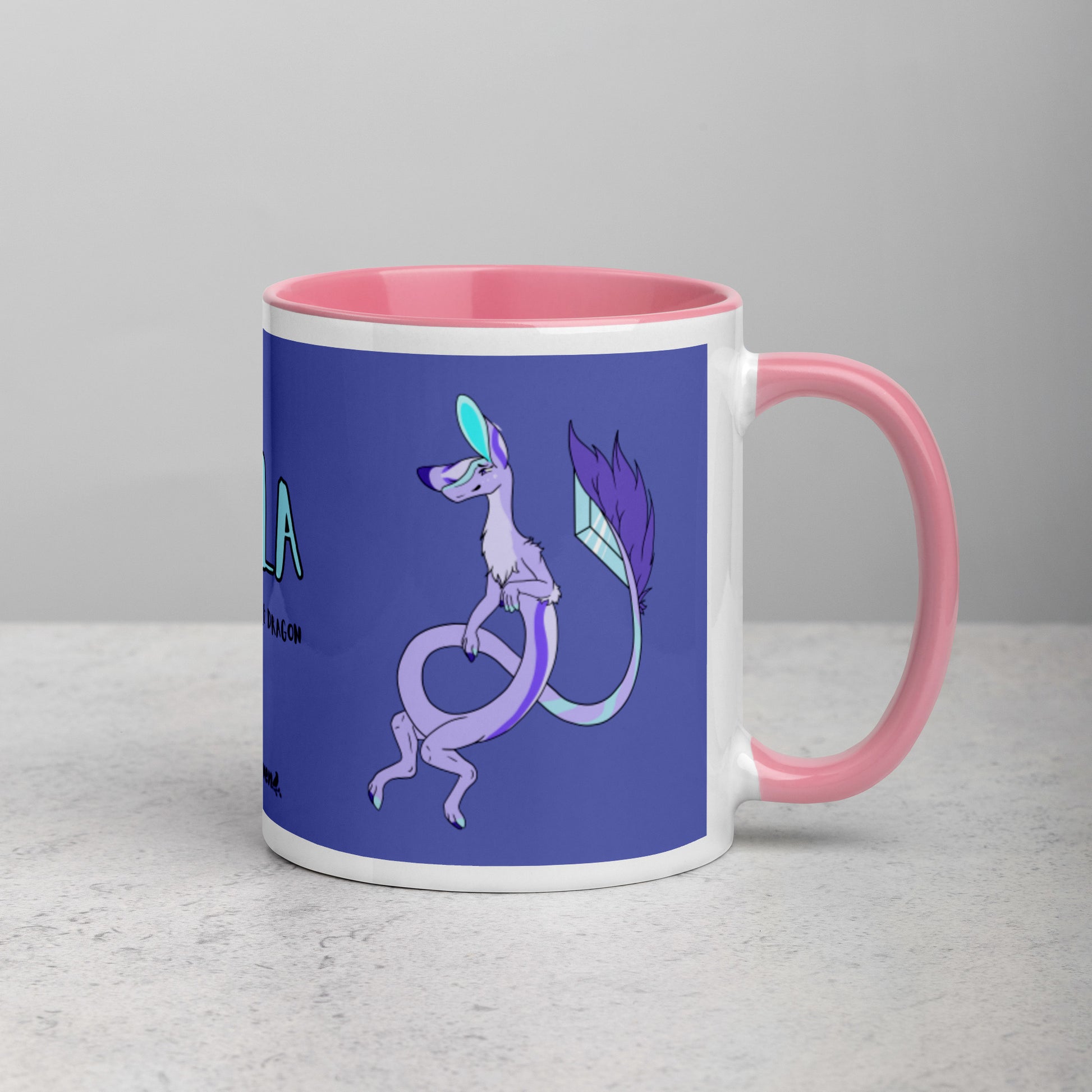 11 ounce white ceramic mug. Pink inside and handle. Features double-sided image of Layla the Lavender Fuzzy Noodle Dragon. Shown on tabletop with handle facing right.
