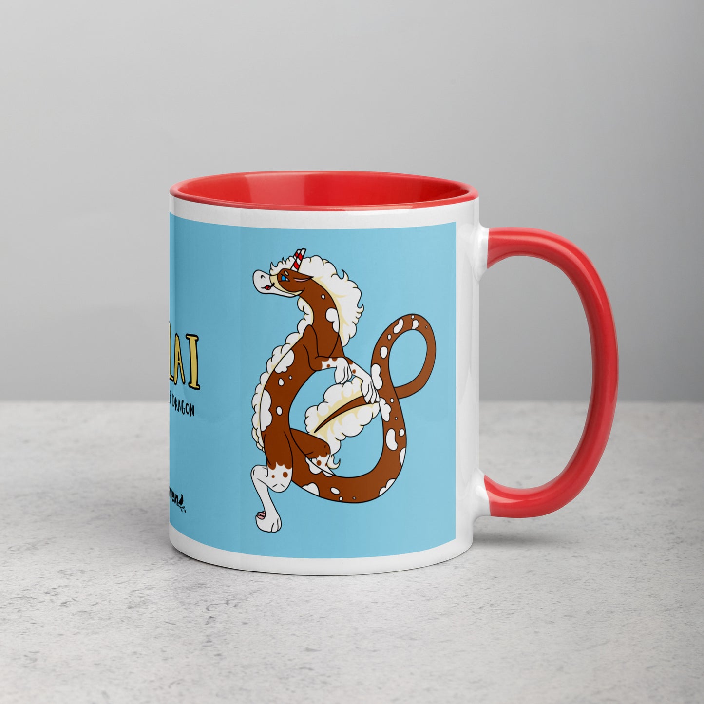 11 ounce ceramic mug with red handle, rim and inside color. Features double-sided image of Nikolai the Fuzzy Noodle Root beer float dragon on a light blue background. Mug is microwave and dishwasher safe.