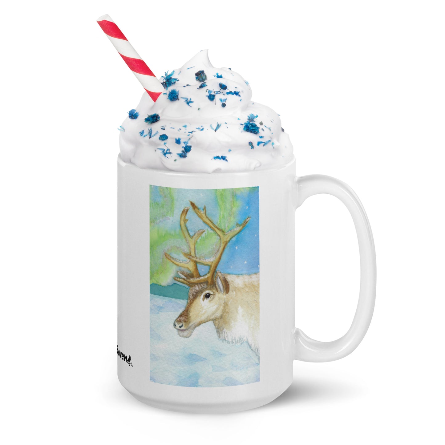 15 ounce ceramic mug featuring Northern Lights reindeer design. Double-sided print. Dishwasher and microwave safe. Shown with handle facing right, filled with whipped cream, sprinkles and a straw.
